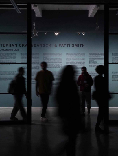 visitors walking through stephan craneanscki and patti smith exhibit at stamba hotel gallery 2023